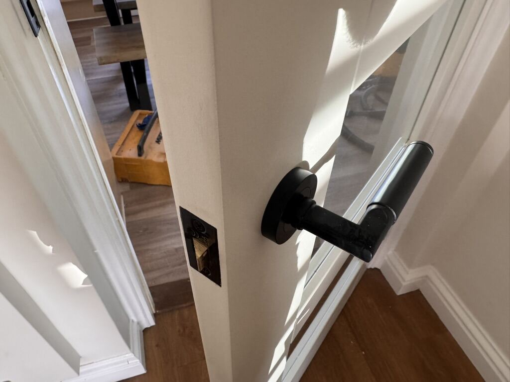 New black door lever handle fitted to a glazed internal door