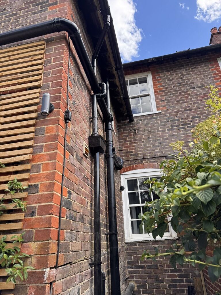 Renewed guttering and downpipes on a brick property